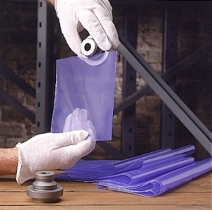 A man placing a metal part in a transparent purple colour VCI Biodegradable Bags